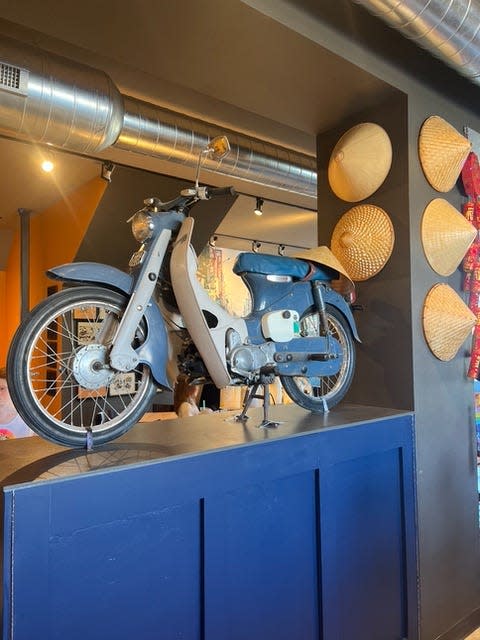 A 1965 Honda Super Cub, the kind of scooter that fills Vietnamese streets, is on display at the new Hue Vietnamese Restaurant dining room. After the cost of importing one from Vietnam proved prohibitive, the owners found this vintage scooter in Boscobel.