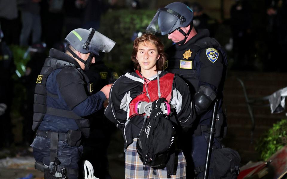 Law enforcement officers detain a protester at UCLA