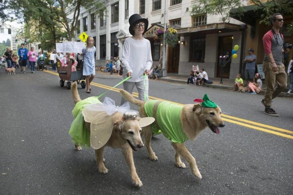 Natalie Gantenbein, 10, of Olympia walks golden retrievers Daisy and Dash with her family’s Peter Pan-themed entry in the 2017 annual Pet Parade in downtown Olympia.