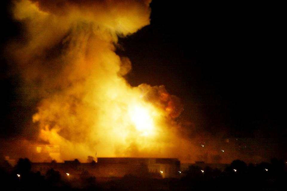 A government building burns during heavy bombardment of Baghdad, Iraq, by U.S.-led forces in this March 21, 2003 file photo. 