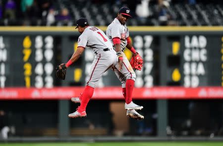 Apr 23, 2019; Denver, CO, USA; Washington Nationals center fielder Victor Robles (16) and shortstop Wilmer Difo (1) celebrate after defeating the Colorado Rockies at Coors Field. Mandatory Credit: Ron Chenoy-USA TODAY Sports