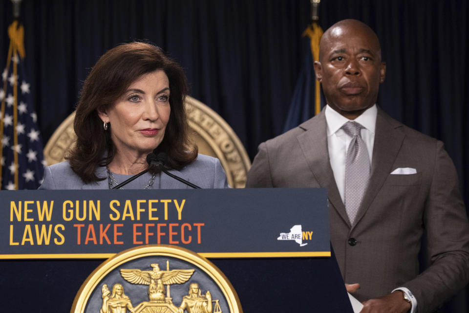 New York Gov. Kathy Hochul, left, and New York City Mayor Eric Adams, right, attend a news conference about upcoming “Gun Free Zone" implementation at Times Square, Wednesday, Aug. 31, 2022, in New York. (AP Photo/Yuki Iwamura)