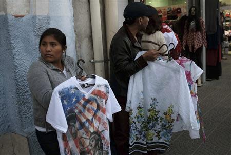 Bolivian immigrants sell clothes along a street, in the Bras neighbourhood of Sao Paulo early morning August 9, 2013. REUTERS/Nacho Doce