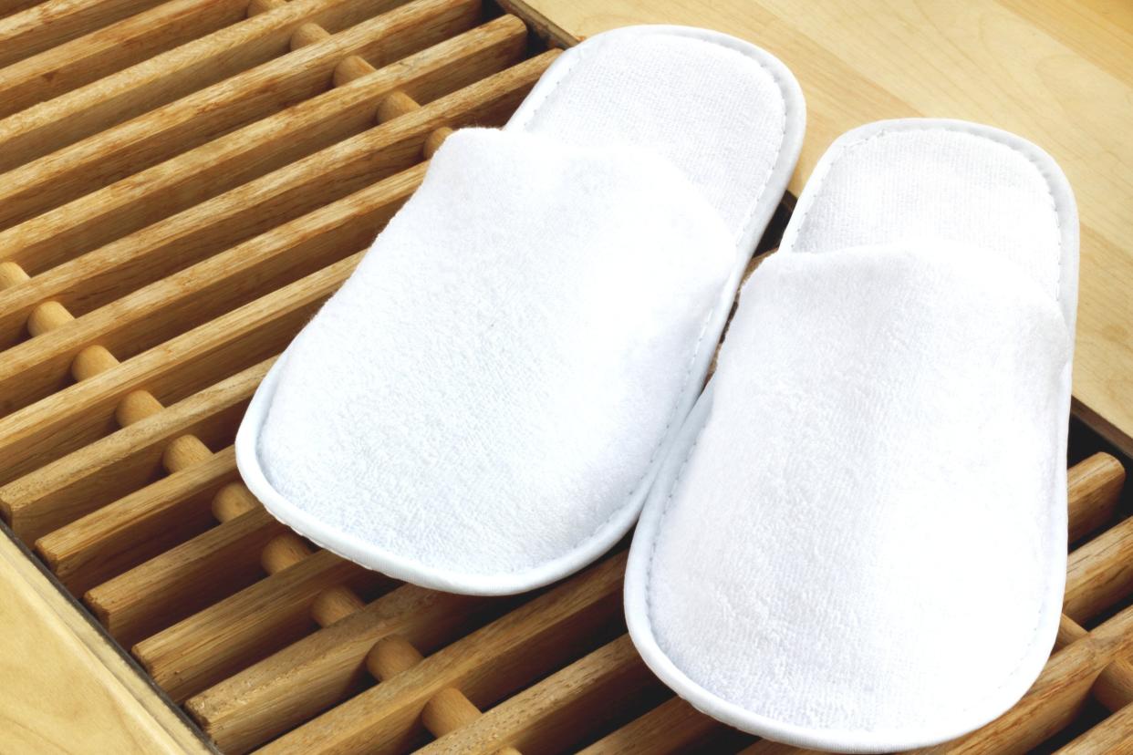 white slippers at a spa on wooden floor