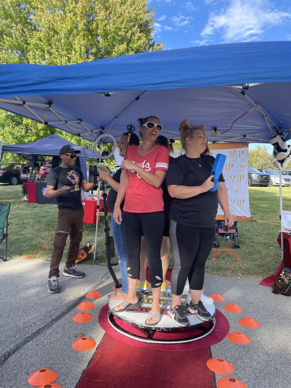 Crown Hill Cemetery Fall Festival attendees take photos at Derek Tuder's Selfie Street Studios 360 booth on Sept. 24, 2023.