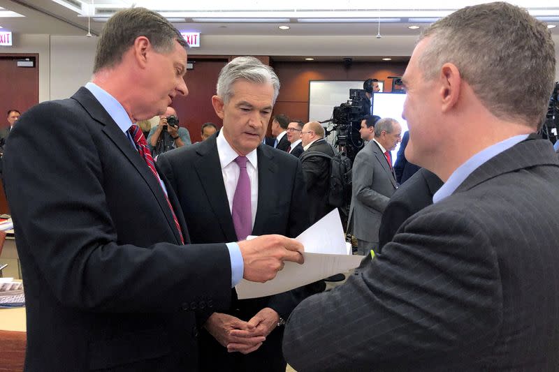 FILE PHOTO: Federal Reserve Chair Jerome Powell speaks with Chicago Fed President Charles Evans and St. Louis Fed President James Bullard at a conference on monetary policy at the Federal Reserve Bank of Chicago