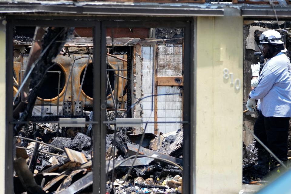 Police investigators work the scene of what remains of the Vero Beach Laundry & Cleaners and Kidz Closet of Vero Beach on Wednesday, May 18, 2022. Both businesses were destroyed in an overnight fire that was reported at 9:15 p.m. Tuesday. A State Fire Marshal investigation is underway to determine the cause.