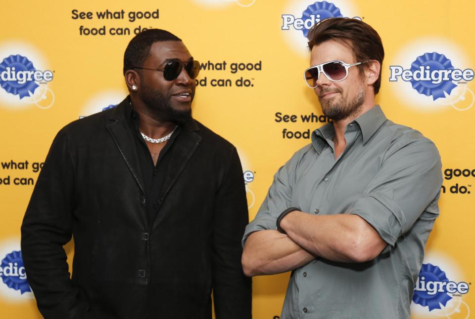 Actor Josh Duhamel, right, borrows someone's sunglasses to jokingly match Boston Red Sox baseball player David Ortiz, left, as they help launch Pedigree Brand's "See what good food can do." documentary-style campaign to help shelter dogs during the 2014 Sundance Film Festival, on Monday, Jan. 20, 2014 in Park City, Utah. (Photo by Danny Moloshok/Invision/AP)