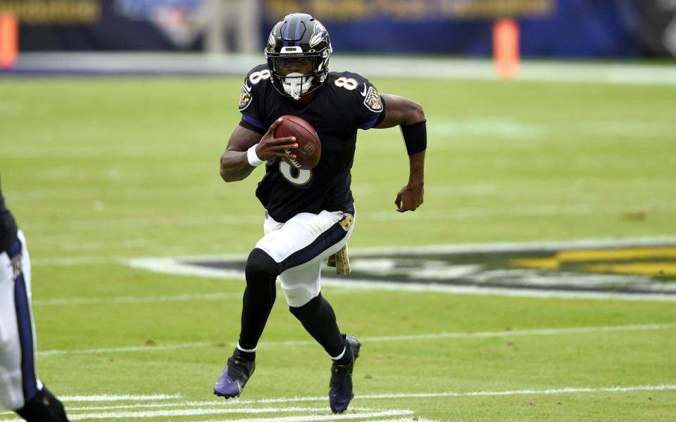 Baltimore Ravens quarterback Lamar Jackson runs with the ball against the Tennessee Titans during the first half of an NFL football game, Sunday, Nov. 22, 2020, in Baltimore. - AP