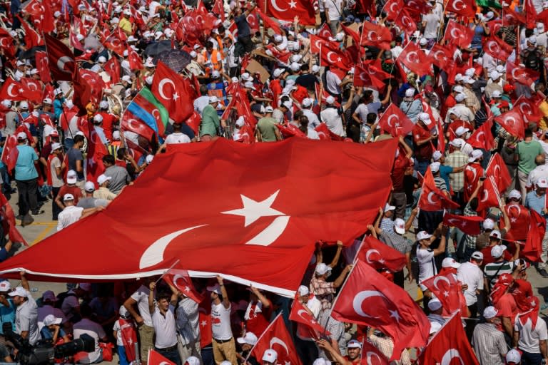 Demonstrators unfurl a giant Turkish flags during a pro-democracy rally in Istanbul, on August 7, 2016