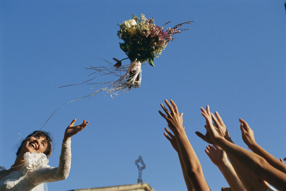 bride throwing her bouquet