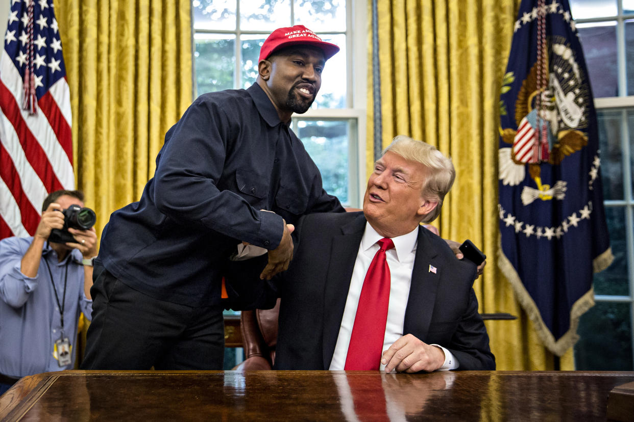 Rapper Kanye West, left, shakes hands with Then-President Donald Trump during a meeting in the Oval Office of the White House on Oct. 11, 2018. (Andrew Harrer / Bloomberg via Getty Images file)