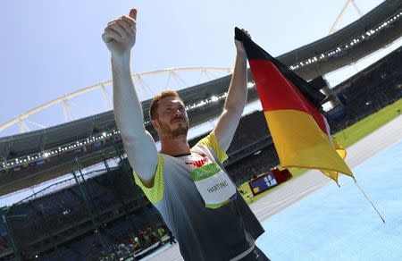 2016 Rio Olympics - Athletics - Final - Men's Discus Throw Final - Olympic Stadium - Rio de Janeiro, Brazil - 13/08/2016. Gold medal winner Christoph Harting (GER) of Germany celebrates. REUTERS/Kai Pfaffenbach