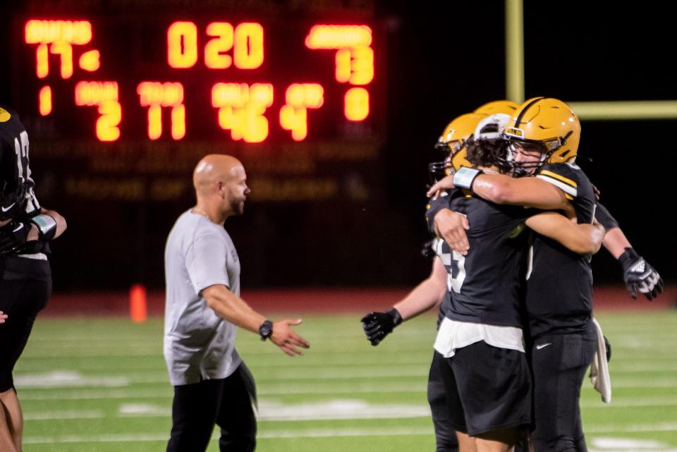 Central Bucks West quarterback Cooper Taylor, right, hugs teammate Ganz Cooper at the end of the Bucks' season home opener against Garnet Valley at War Memorial Field in Doylestown Borough on Friday, August 25, 2023. The Bucks defeated the Jaguars 17-13.