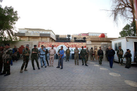 Iraqi security forces stands guard outside the main provincial government building Basra, Iraq July 14, 2018. Picture taken July 14, 2018. REUTERS/Essam al-Sudani