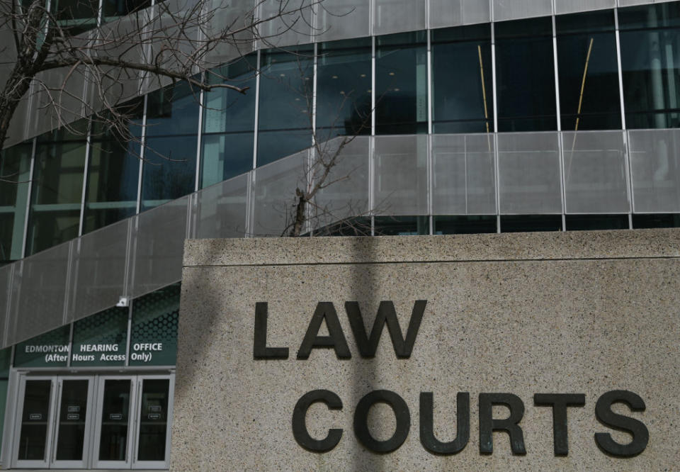 Exterior view of a building with "LAW COURTS" sign in the foreground