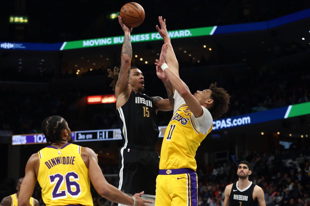 Memphis Grizzlies forward Brandon Clarke (15) shoots as Los Angeles Lakers center Jaxson Hayes (11) defends during the second half at FedExForum on March 27, 2024. It was Clarke's first game since suffering a torn Achilles more than a year earlier.