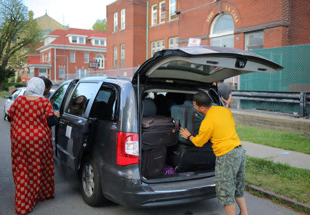 A taxi is loaded with bags outside Vive La Casa shelter before transporting a family from El Salvador to file a refugee claim at the Canadian border, in Buffalo, New York, U.S. July 5, 2017. Picture taken July 5, 2017. REUTERS/Chris Helgren