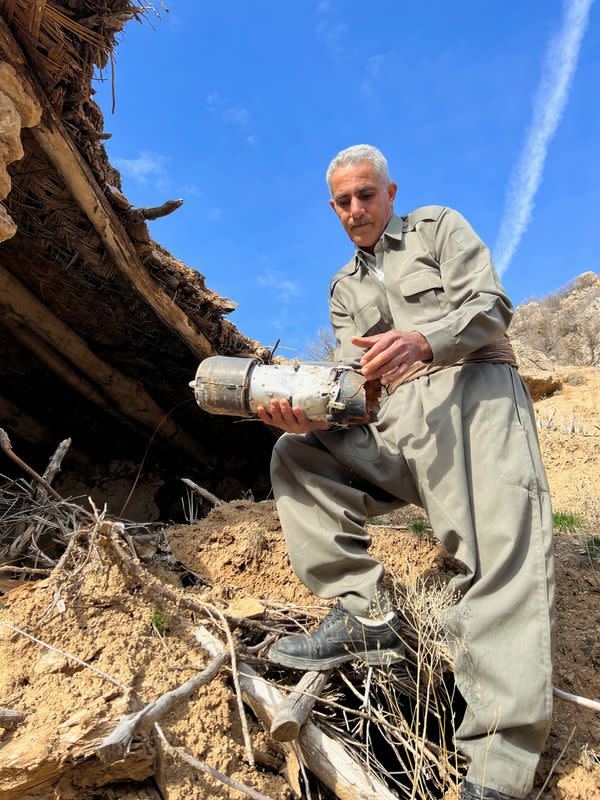 A Sararo villager shows the damage, he says, was caused by Turkish bombardment on their village, in Dohuk