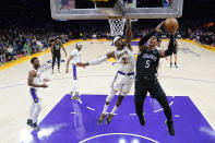 Orlando Magic forward Paolo Banchero (5) shoots over Los Angeles Lakers forward Jarred Vanderbilt (2) during the first half of an NBA basketball game Sunday, March 19, 2023, in Los Angeles. (AP Photo/Marcio Jose Sanchez)