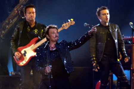 FILE PHOTO: French rock singer Johnny Hallyday (L) performs at the Stade de France in Saint Denis, Paris suburb, France, May 29, 2009. REUTERS/Philippe Wojazer/File Photo