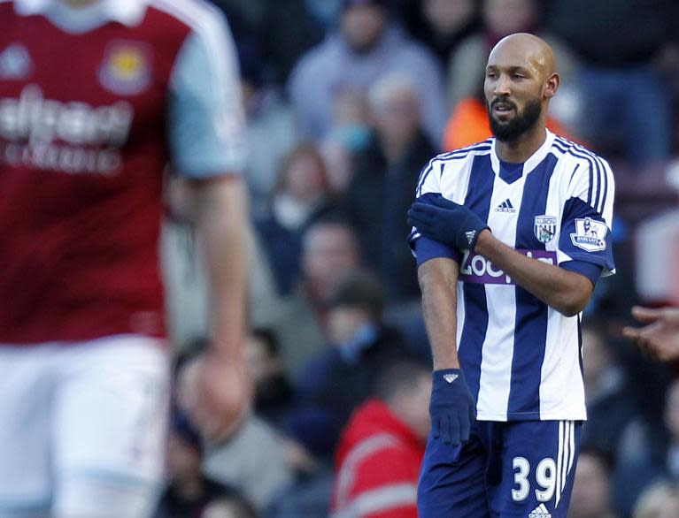 West Bromwich Albion's striker Nicolas Anelka celebrates scoring their second goal during an English Premier League football match against West Ham United at The Boleyn Ground, Upton Park in east London on December 28, 2013