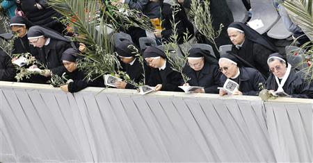 Nuns pray before Pope Francis arrives to lead the Palm Sunday mass at Saint Peter's Square at the Vatican April 13, 2014. REUTERS/Giampiero Sposito