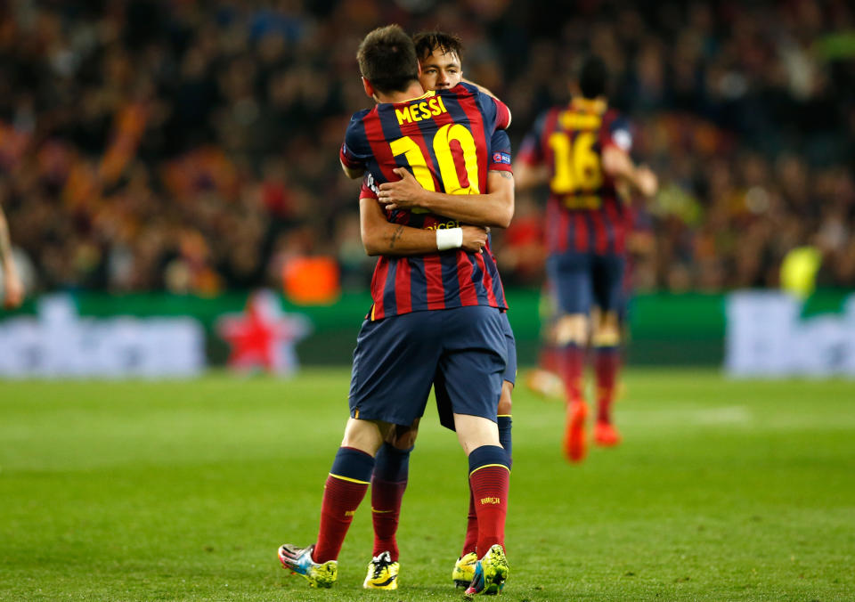 Barcelona's Neymar celebrates with teammate Lionel Messi, left, after scoring his side's first goal during a first leg quarterfinal Champions League soccer match between Barcelona and Atletico Madrid at the Camp Nou stadium in Barcelona, Spain, Tuesday April 1, 2014. (AP Photo/Emilio Morenatti)