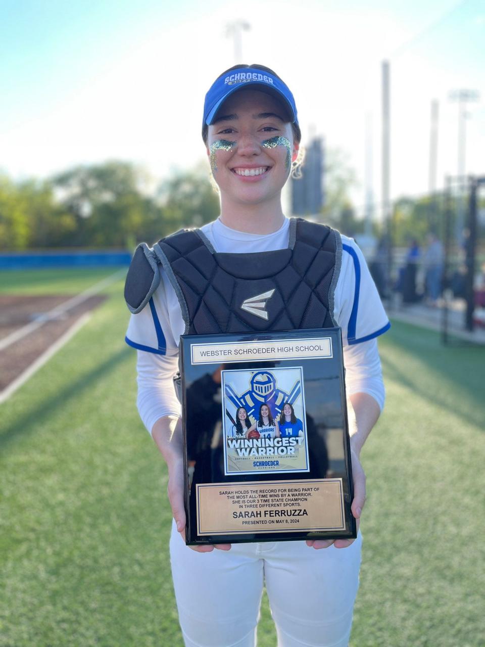 Webster Schroeder senior Sarah Ferruzza was honored as the Warriors' all-time winningest athlete. A state champion in softball, basketball and volleyball, Ferruzza won her 179th game after a 4-3 win over Fairport Wednesday, May 8, 2024 in Webster.