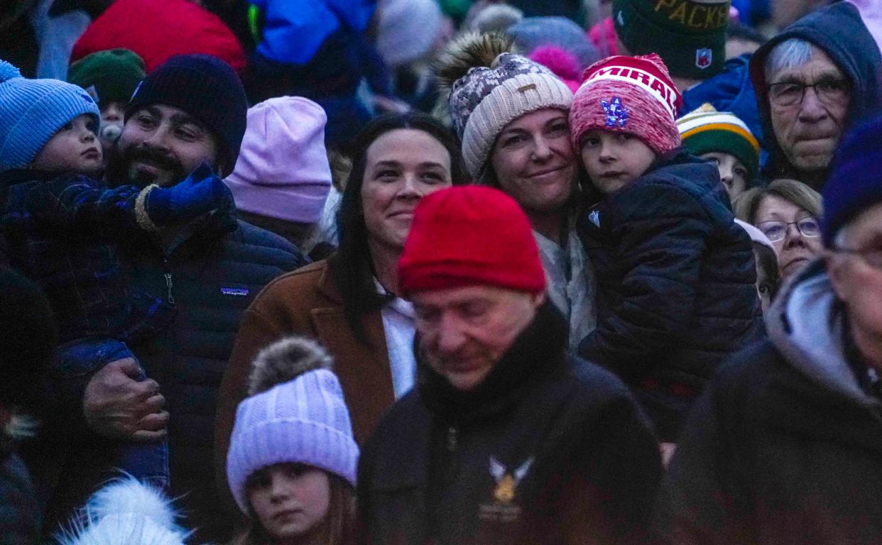 Families hold their little ones and enjoy music being performed from the Canadian Pacific Holiday Train Monday, Dec. 4, 2023, in Wauwatosa, Wis. Ebony Cox / Milwaukee Journal Sentinel