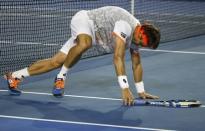 Spain's David Ferrer falls over during his quarter-final match against Britain's Andy Murray at the Australian Open tennis tournament at Melbourne Park, Australia, January 27, 2016. REUTERS/Issei Kato