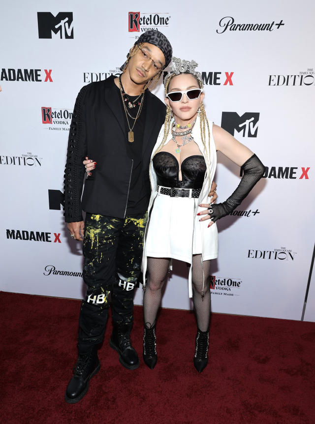 Ahlamalik Williams and Madonna standing together on the red carpet wearing alternative fashion
