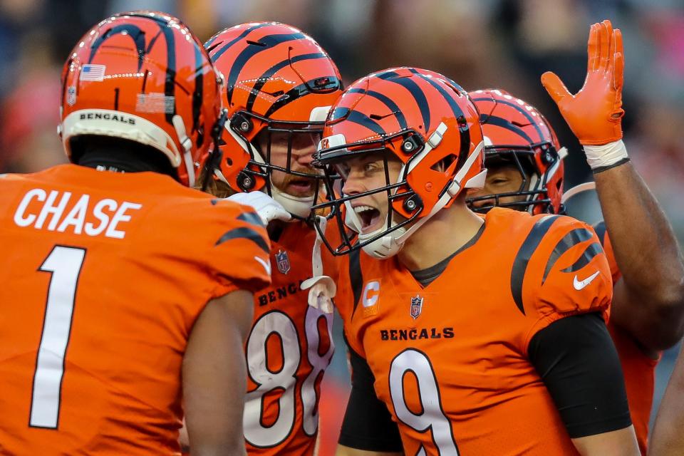 Cincinnati Bengals quarterback Joe Burrow (9) celebrates with teammates after scoring a touchdown against the Kansas City Chiefs in the first half at Paycor Stadium.