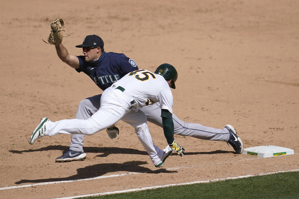Seattle Mariners' Evan White, left, forces out Oakland Athletics' Nate Orf at first base during the sixth inning of a baseball game in Oakland, Calif., Sunday, Sept. 27, 2020. (AP Photo/Jeff Chiu)