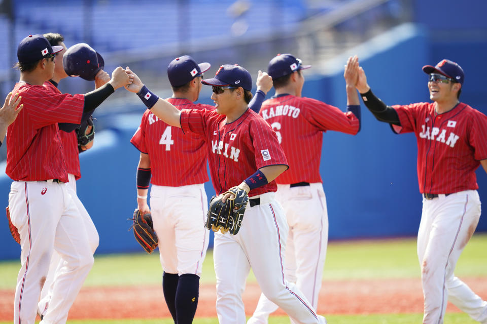 Japan's Masataka Yoshida, center, celebrates with teammates after Japan won a baseball game against Mexico at Yokohama Baseball Stadium during the 2020 Summer Olympics, Saturday, July 31, 2021, in Yokohama, Japan. (AP Photo/Matt Slocum)