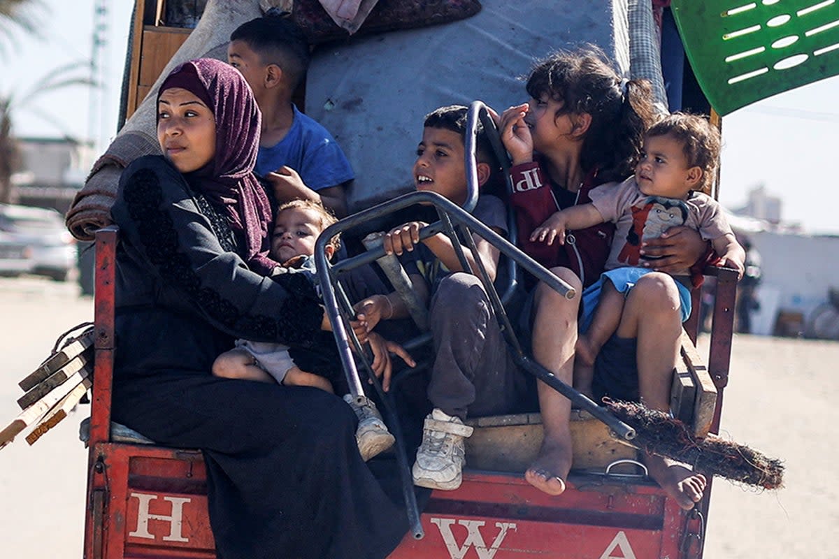 Palestinians travel in a vehicle as they flee Rafah  (Reuters)