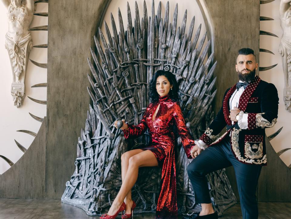 Owners Robert and Krystal Rivani sitting on the replica of the iron throne in "Game of Thrones"