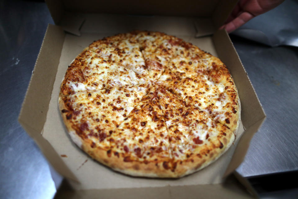 A pizza comes out of the oven at Domino's Pizza restaurant in Los Angeles, California, U.S. July 18, 2018. REUTERS/Lucy Nicholson