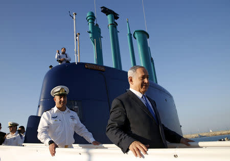 FILE PHOTO: Israeli Prime Minister Benjamin Netanyahu stands ona a navy submarine after it arrived in Haifa port, Israel January 12, 2016. REUTERS/Baz Ratner/File Photo