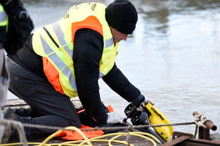A volunteer of Israeli rescue and recovery organisation ZAKA pulls an underwater sonar from the Danube river during a search for the remains of Holocaust victims murdered on the banks of the river in 1944 in Budapest, Hungary January 15, 2019. REUTERS/Tamas Kaszas
