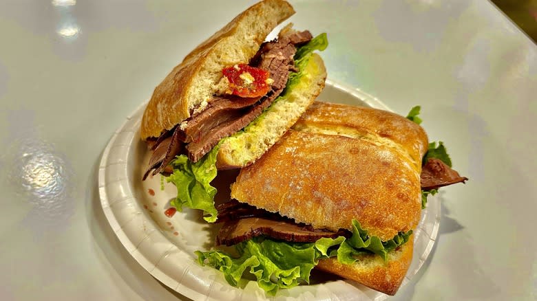 Sandwich with meat, lettuce, and tomato