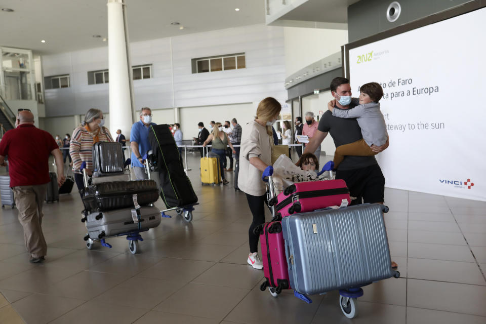 Passengers of a flight from the United Kingdom arrive at Faro airport, outside Faro, in Portugal's southern Algarve region, Monday, May 17, 2021. British vacationers began arriving in large numbers in southern Portugal on Monday for the first time in more than a year, after governments in the two countries eased their COVID-19 pandemic travel restrictions. (AP Photo/Ana Brigida)