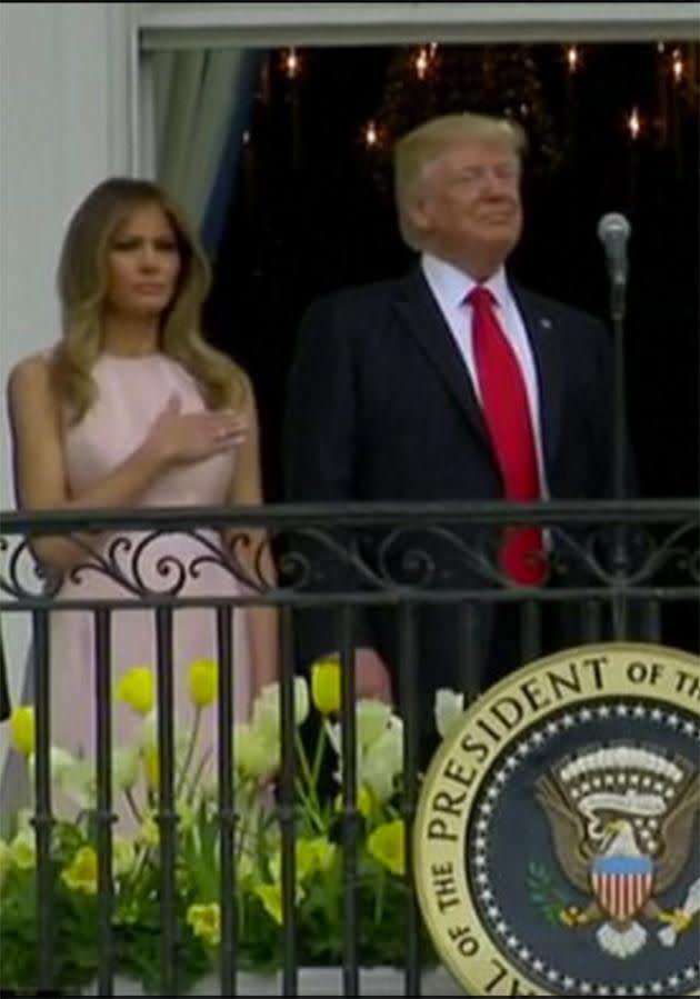 Melania Trump had to nudge her husband to get him to raise his hand to his heart during the National Anthem. Photo: WH