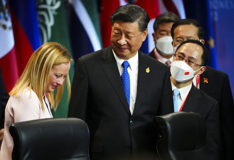 Chinese President Xi Jinping talks with Italian Prime Minister Giorgia Meloni as they takes part in the first working session at the G20 leaders summit in Nusa Dua, Bali.