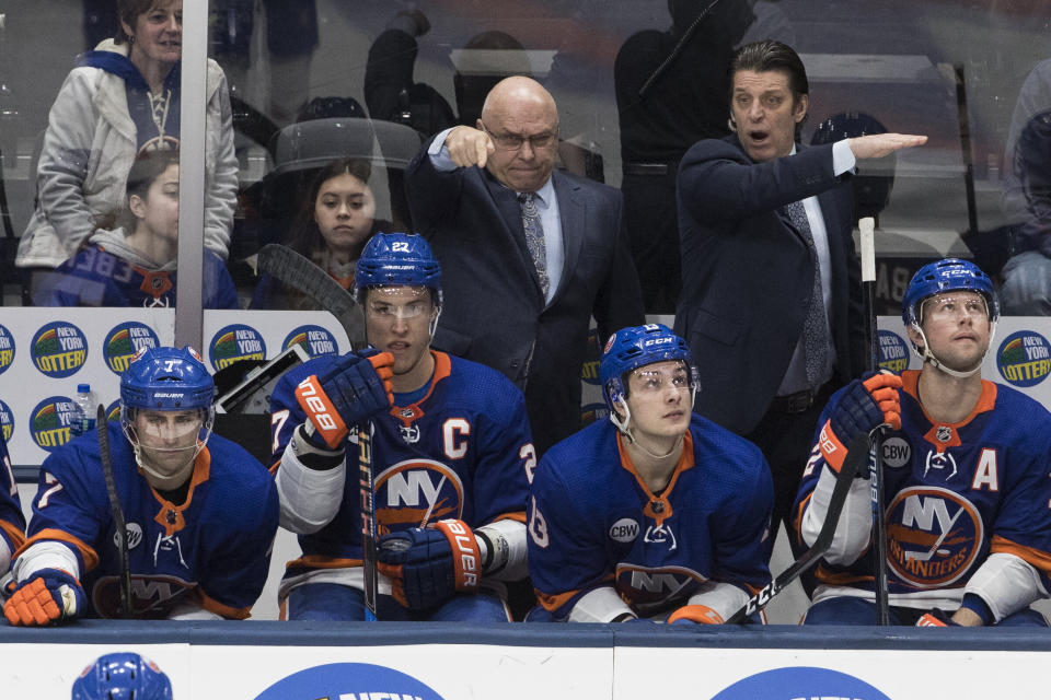 New York Islanders head coach Barry Trotz, back left, gestures during the third period of an NHL hockey game against the Montreal Canadiens, Thursday, March 14, 2019, in Uniondale, N.Y. (AP Photo/Mary Altaffer)