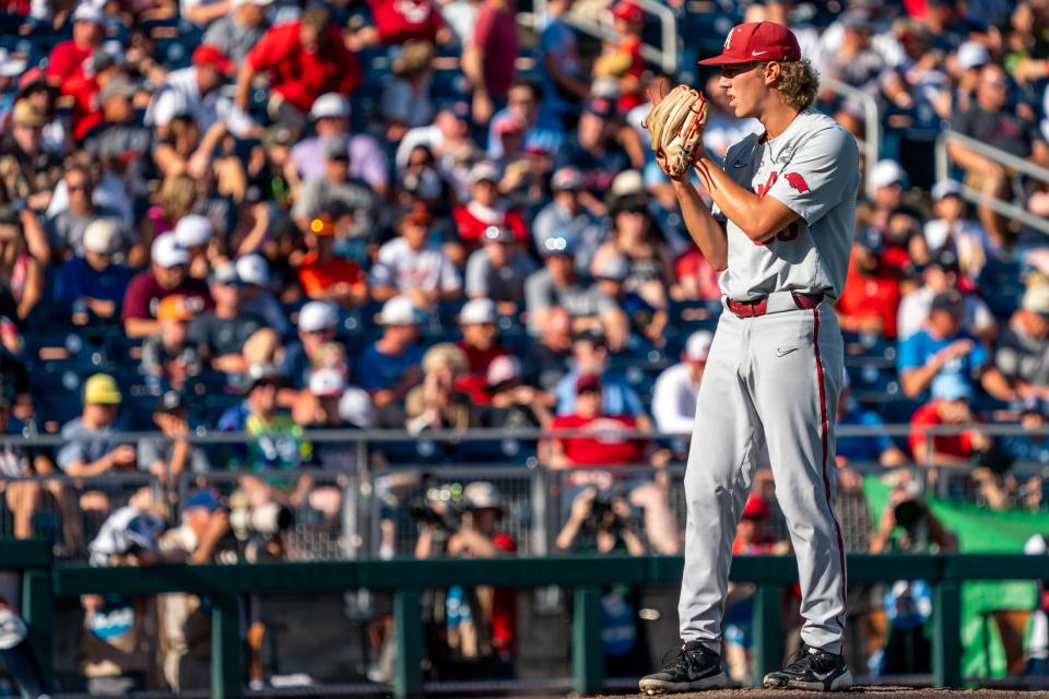 Jun 22, 2022; Omaha, NE, USA; Arkansas Razorbacks starting pitcher Hagen Smith (33) pitches against the Ole Miss Rebels during the first inning at Charles Schwab Field. Mandatory Credit: Dylan Widger-USA TODAY Sports