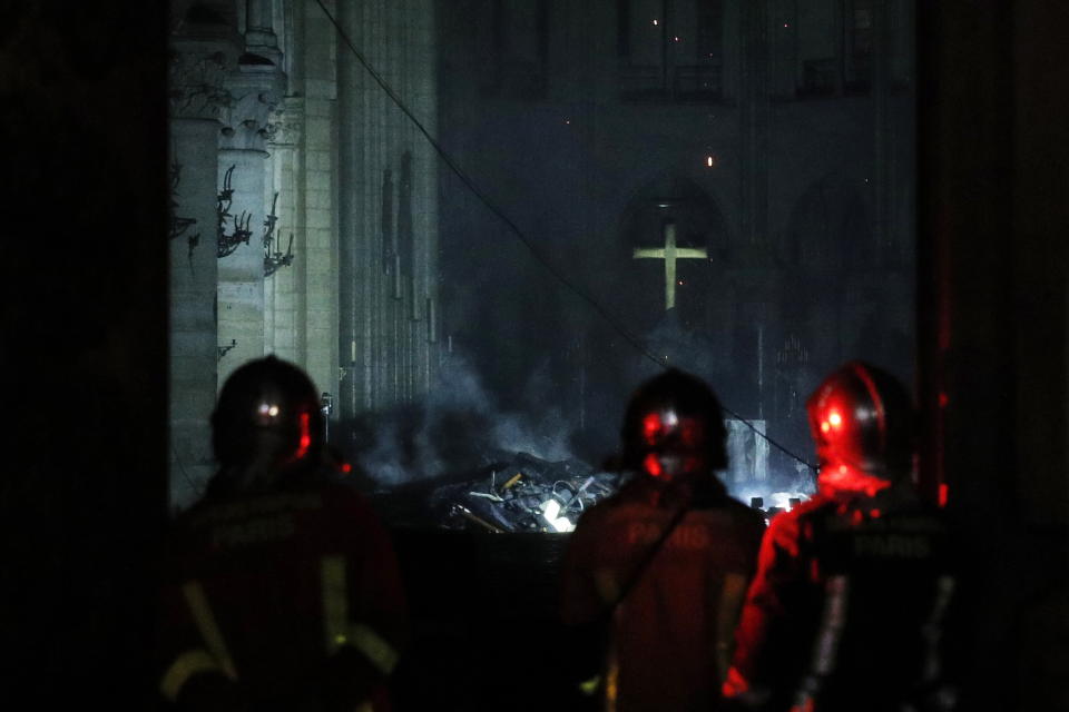 Firefighters gaze at the damage caused.Source: AAP