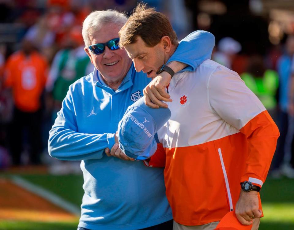 North Carolina coach Mack Brown embraces Clemson coach Dabo Swinney prior to their game on Saturday, November 18, 2023 at Memorial Stadium in Clemson, S.C.