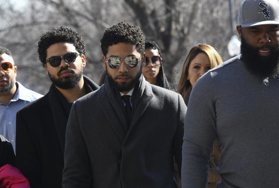 "Empire" actor Jussie Smollett, center, arrives at Leighton Criminal Court Building for a hearing to discuss whether cameras will be allowed in the courtroom during his disorderly conduct case on Tuesday, March 12, 2019, in Chicago. A grand jury indicted Smollett last week on 16 felony counts accusing him of lying to the police about being the victim of a racist and homophobic attack by two masked men in downtown Chicago.(AP Photo/Matt Marton)