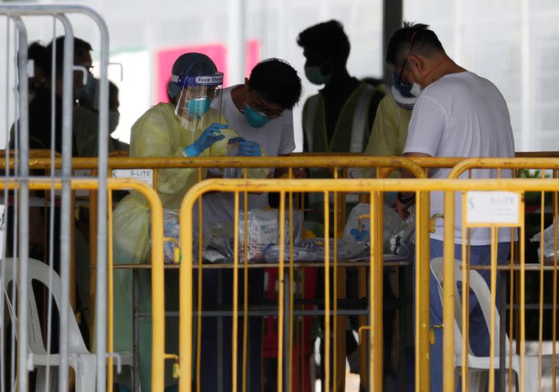 Medical personnel sort out medical supplies at a dormitory during the coronavirus disease (COVID-19) outbreak in Singapore